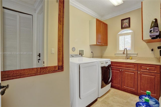 washroom with sink, cabinets, ornamental molding, light tile patterned floors, and independent washer and dryer