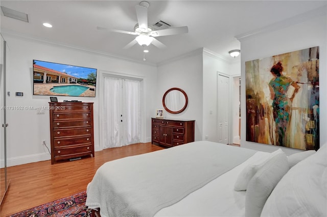 bedroom with crown molding, ceiling fan, and light wood-type flooring