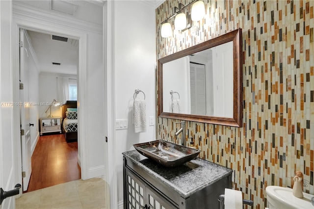 bathroom featuring crown molding, tile patterned floors, vanity, and toilet