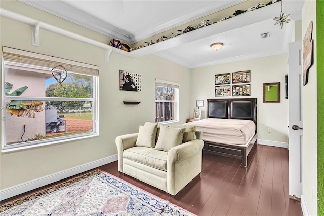 bedroom with ornamental molding, dark hardwood / wood-style floors, and multiple windows