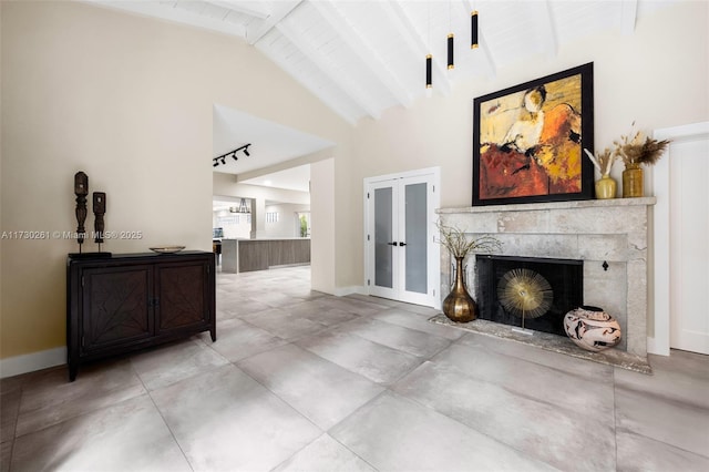 living room with concrete flooring, high vaulted ceiling, a fireplace, beamed ceiling, and french doors