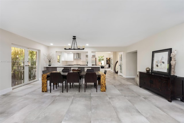 dining space featuring french doors and a chandelier