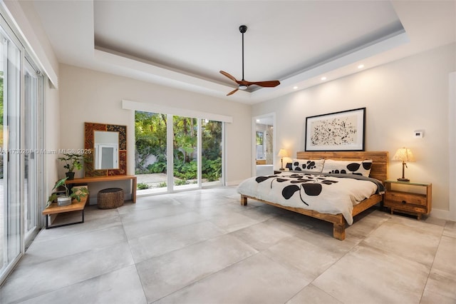 bedroom with ceiling fan and a raised ceiling