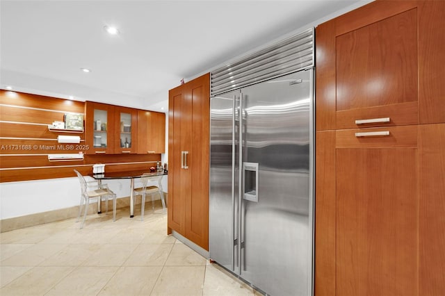 kitchen featuring light tile patterned flooring and built in fridge