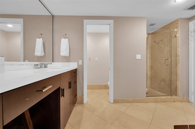 bathroom with vanity, tile patterned flooring, and a shower with shower door