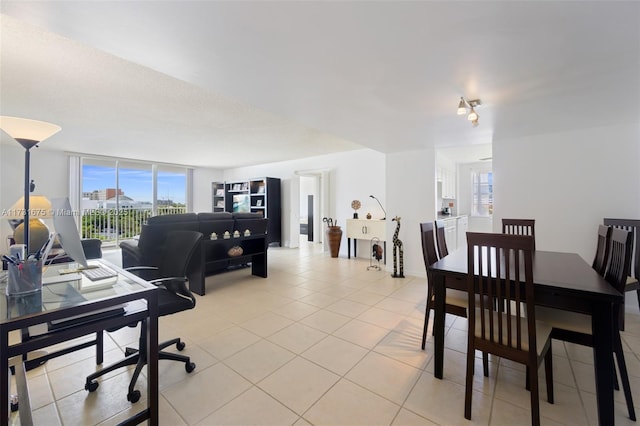 dining space with light tile patterned floors and floor to ceiling windows