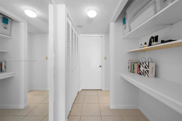 hall featuring light tile patterned floors