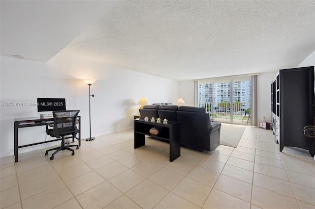 tiled living room featuring floor to ceiling windows and a textured ceiling