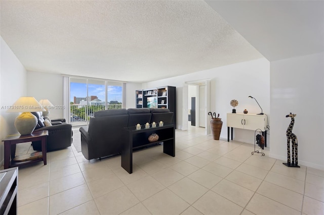 living room with expansive windows, light tile patterned flooring, and a textured ceiling