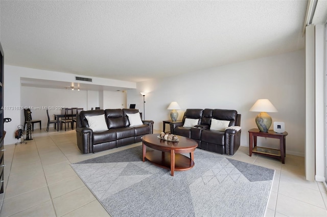 living room with light tile patterned floors and a textured ceiling
