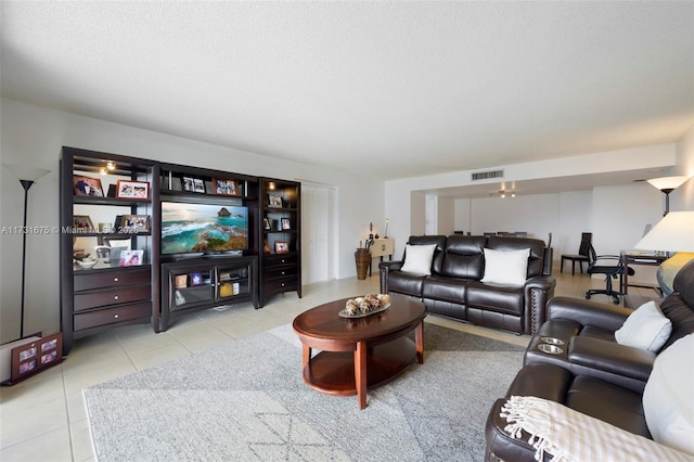 living room featuring light tile patterned floors and a textured ceiling
