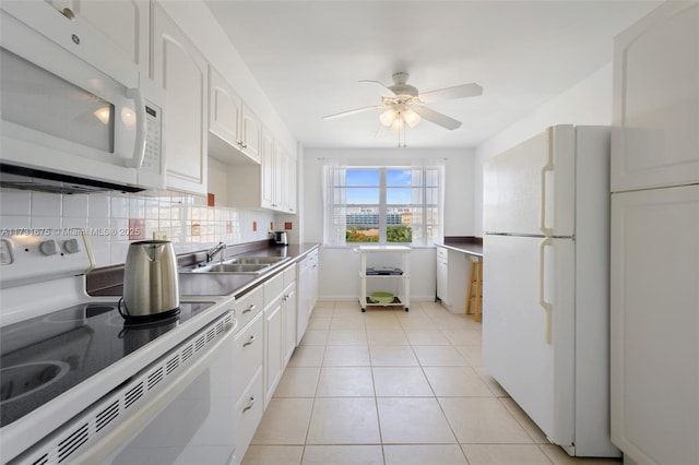 kitchen with sink, tasteful backsplash, light tile patterned floors, white appliances, and white cabinets