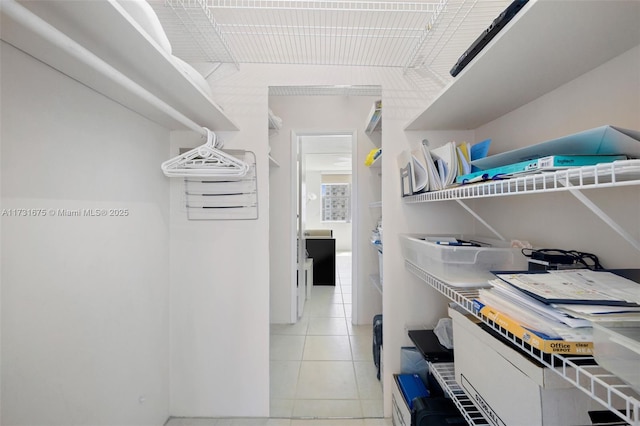 walk in closet featuring light tile patterned flooring
