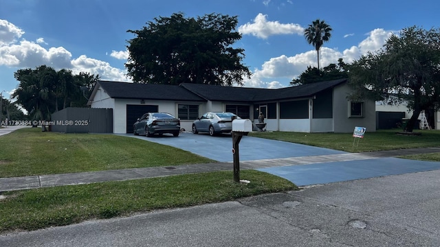 ranch-style house featuring a garage and a front lawn