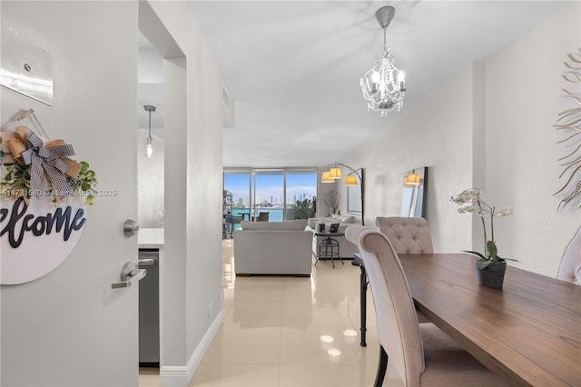 tiled dining room featuring floor to ceiling windows and a chandelier