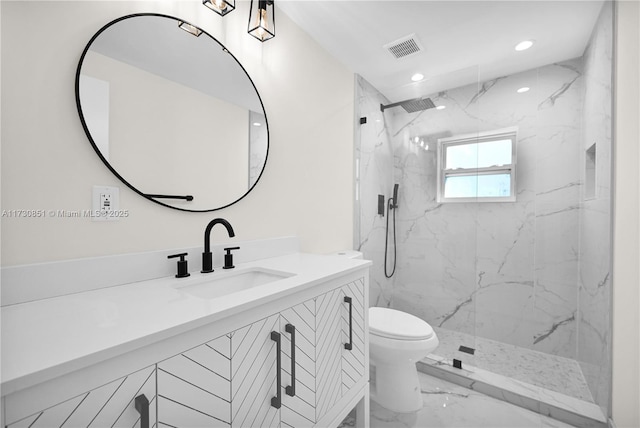 full bathroom featuring a marble finish shower, visible vents, toilet, marble finish floor, and vanity