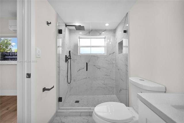 bathroom with toilet, marble finish floor, a marble finish shower, and baseboards