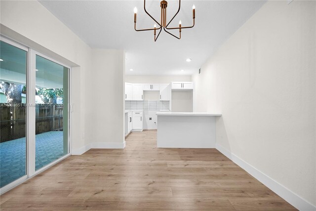 spare room featuring a textured ceiling, ceiling fan, and light wood-type flooring