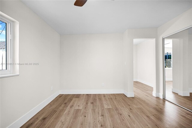 unfurnished room with ceiling fan and light wood-type flooring