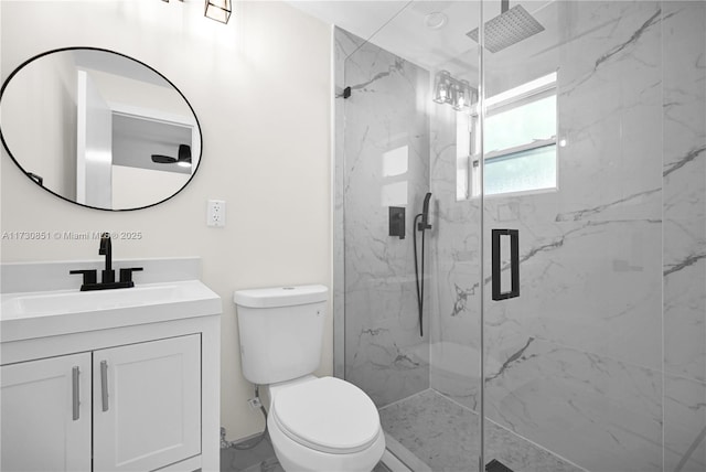 full bathroom featuring marble finish floor, toilet, vanity, and a marble finish shower