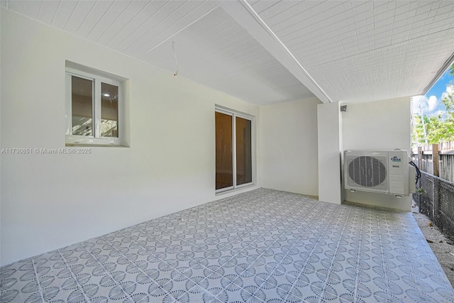 view of patio featuring ac unit and fence