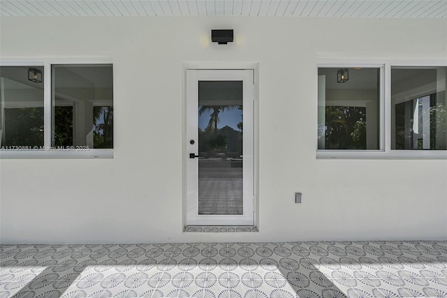 entrance to property featuring stucco siding