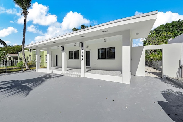 back of property featuring a patio area, fence, and stucco siding