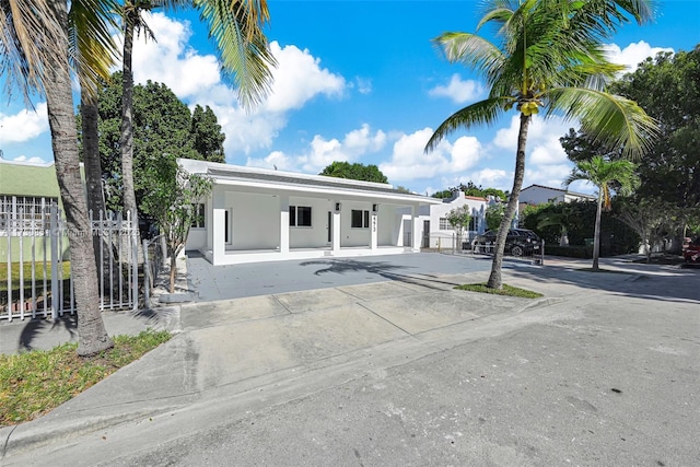 view of front of house with fence and stucco siding