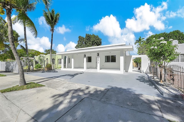 view of front of home with fence and stucco siding