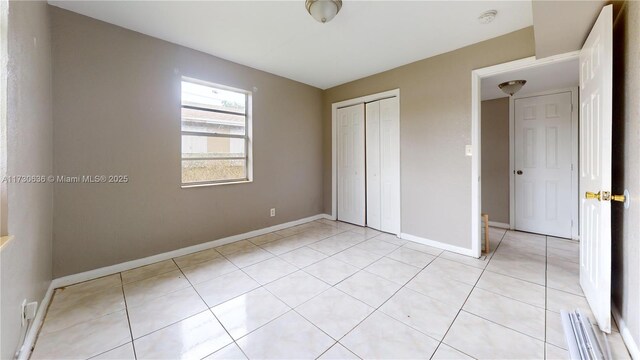 kitchen featuring sink, backsplash, light tile patterned floors, electric panel, and stainless steel electric range