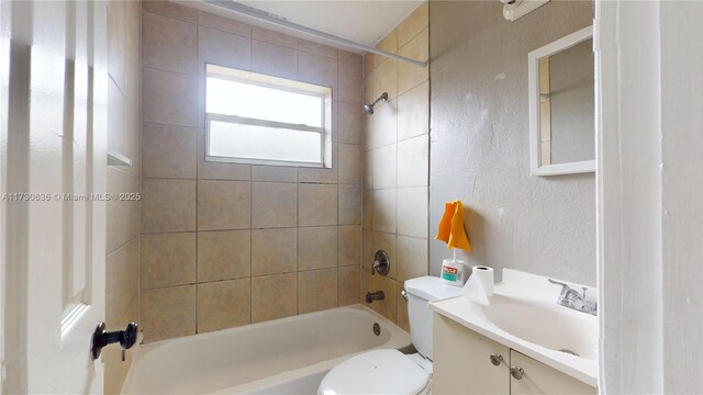 full bathroom with vanity, toilet, and tiled shower / bath