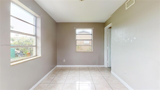 bedroom with light tile patterned flooring, connected bathroom, and cooling unit