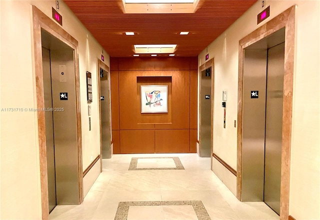 hall featuring elevator and wooden ceiling