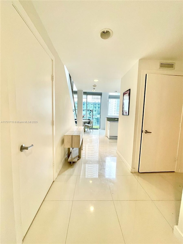 hallway featuring tile patterned flooring