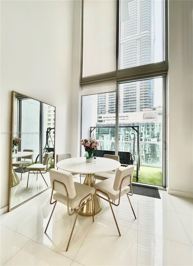 dining room with expansive windows and tile patterned flooring