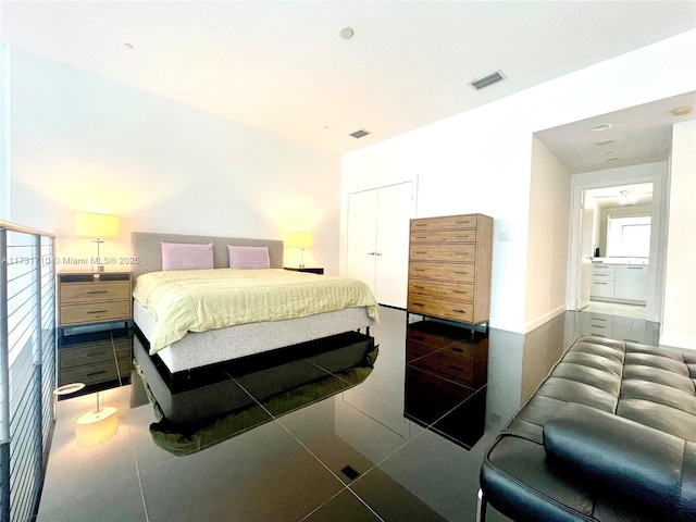 bedroom featuring dark tile patterned flooring