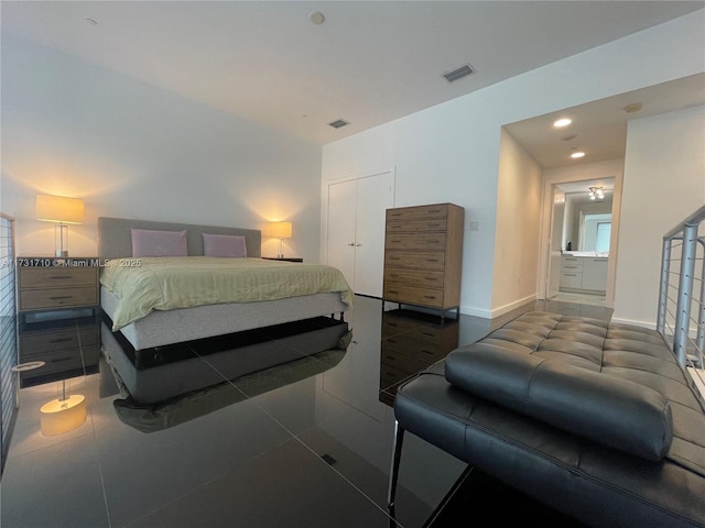 bedroom with dark tile patterned floors