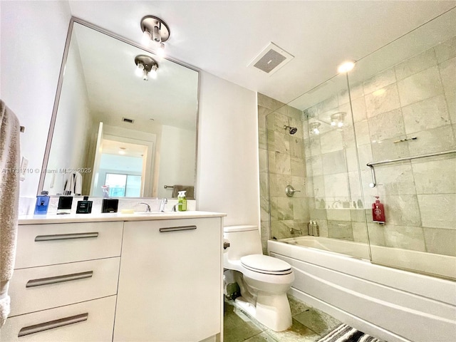 full bathroom with vanity, toilet, and tiled shower / bath combo