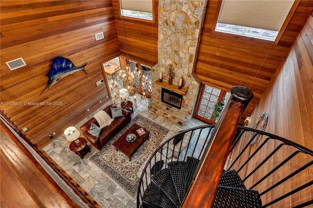 living room with high vaulted ceiling and wood walls