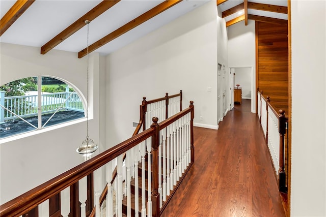 corridor with beam ceiling, dark wood-type flooring, and high vaulted ceiling