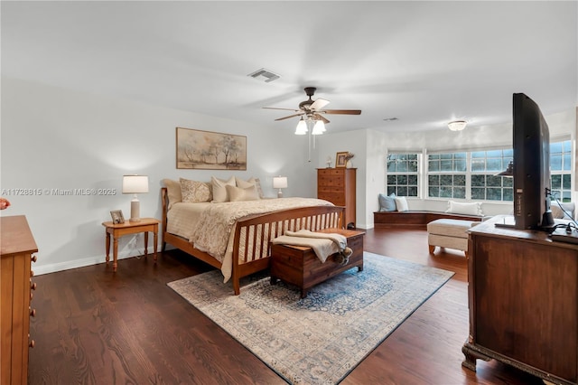 bedroom with dark hardwood / wood-style floors and ceiling fan