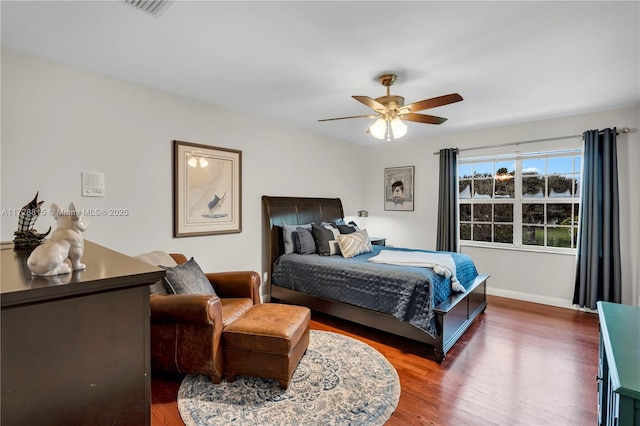 bedroom with dark wood-type flooring and ceiling fan