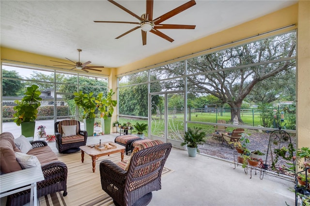 sunroom / solarium featuring ceiling fan