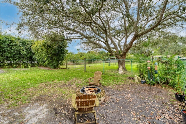 view of yard with a fire pit