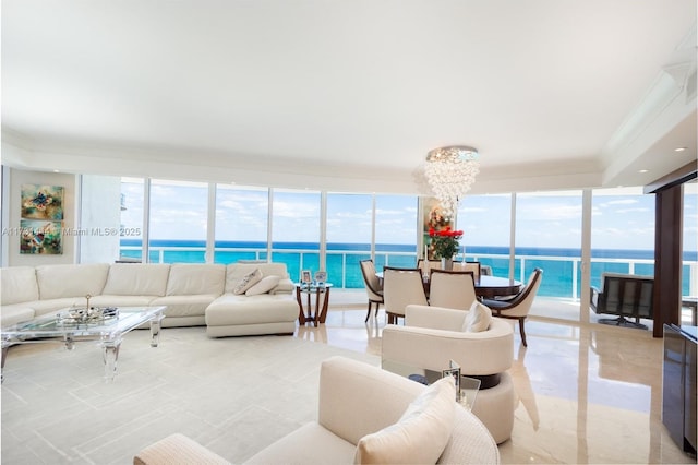 living room featuring an inviting chandelier, ornamental molding, and a water view