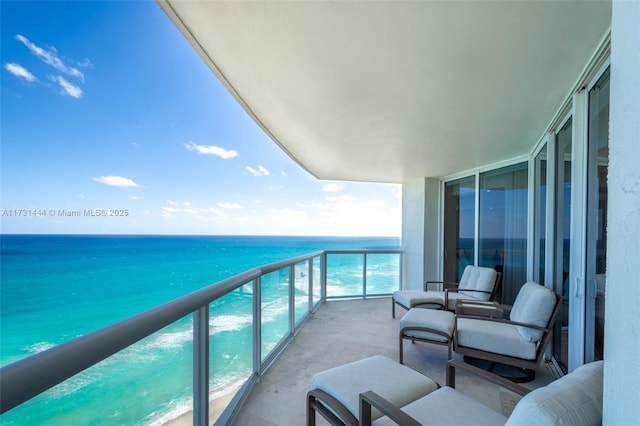 balcony with a water view and a beach view