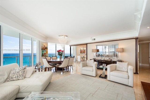 living room with crown molding, a water view, and a chandelier