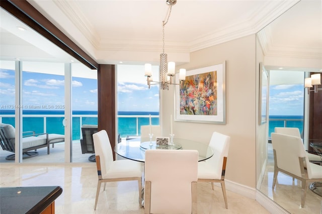 dining area featuring ornamental molding, a water view, a chandelier, and a wall of windows