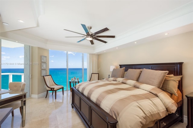 bedroom with ceiling fan and a water view