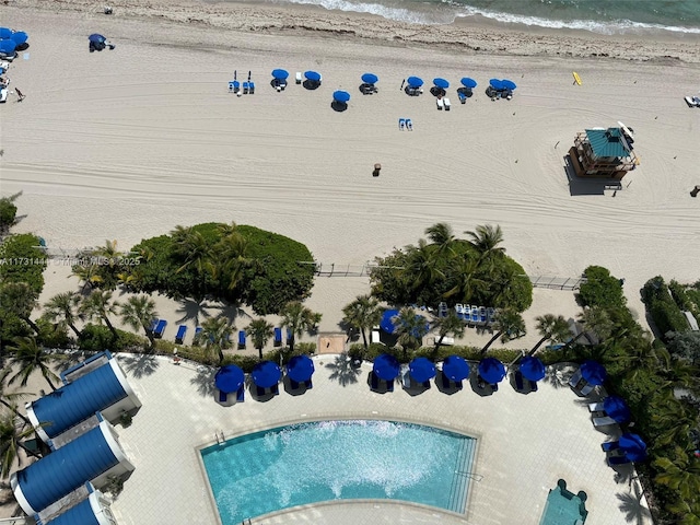 drone / aerial view with a water view and a beach view